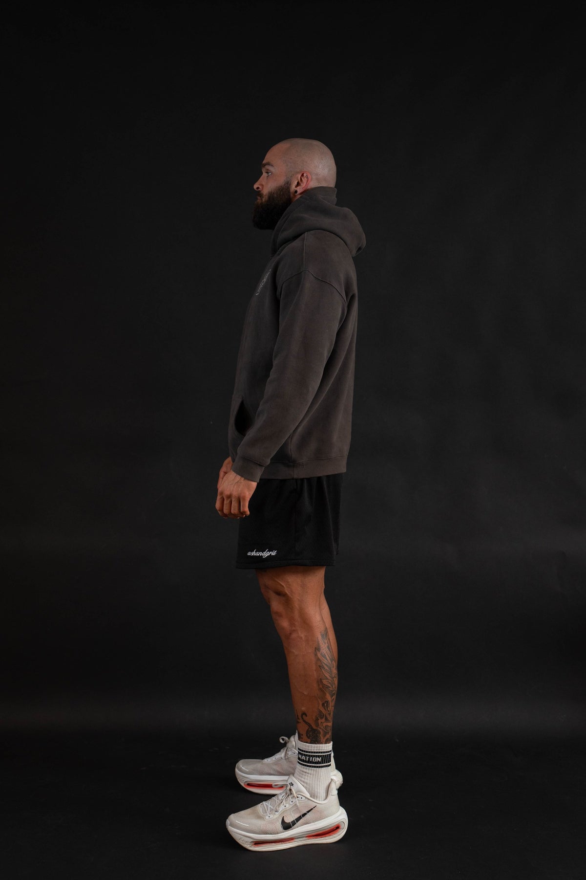 Championship Hoodie side view with sleeve print, on a male model
