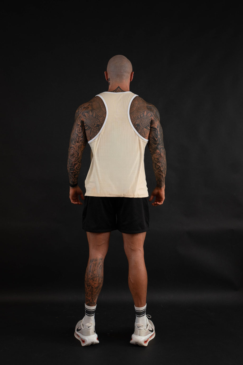 Essential Piped Stringer in Sandstone Tan, racerback view on a male model