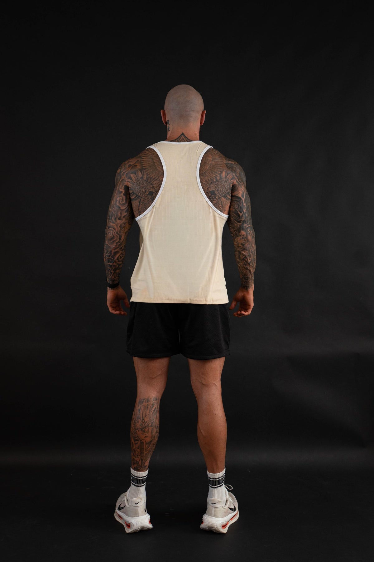 Essential Piped Stringer in Sandstone Tan, racerback view on a male model