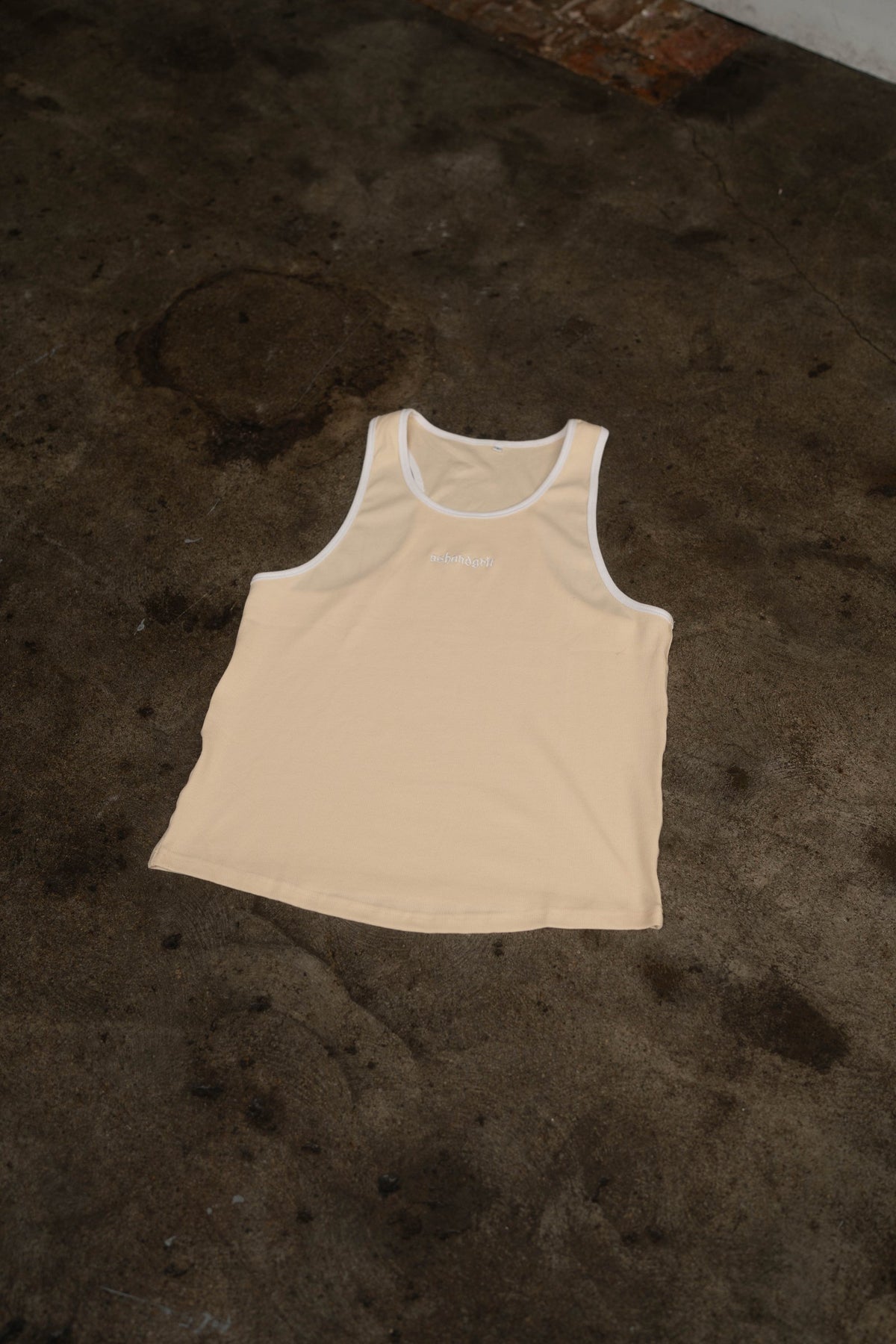 Essential Piped Stringer in Sandstone Tan, flat lay