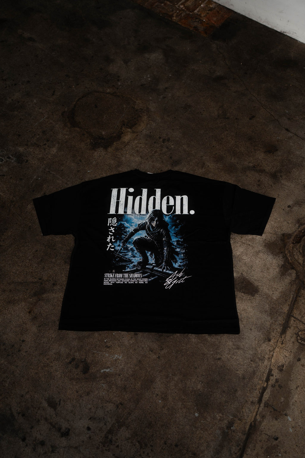 Hidden T-Shirt back graphic, flat lay