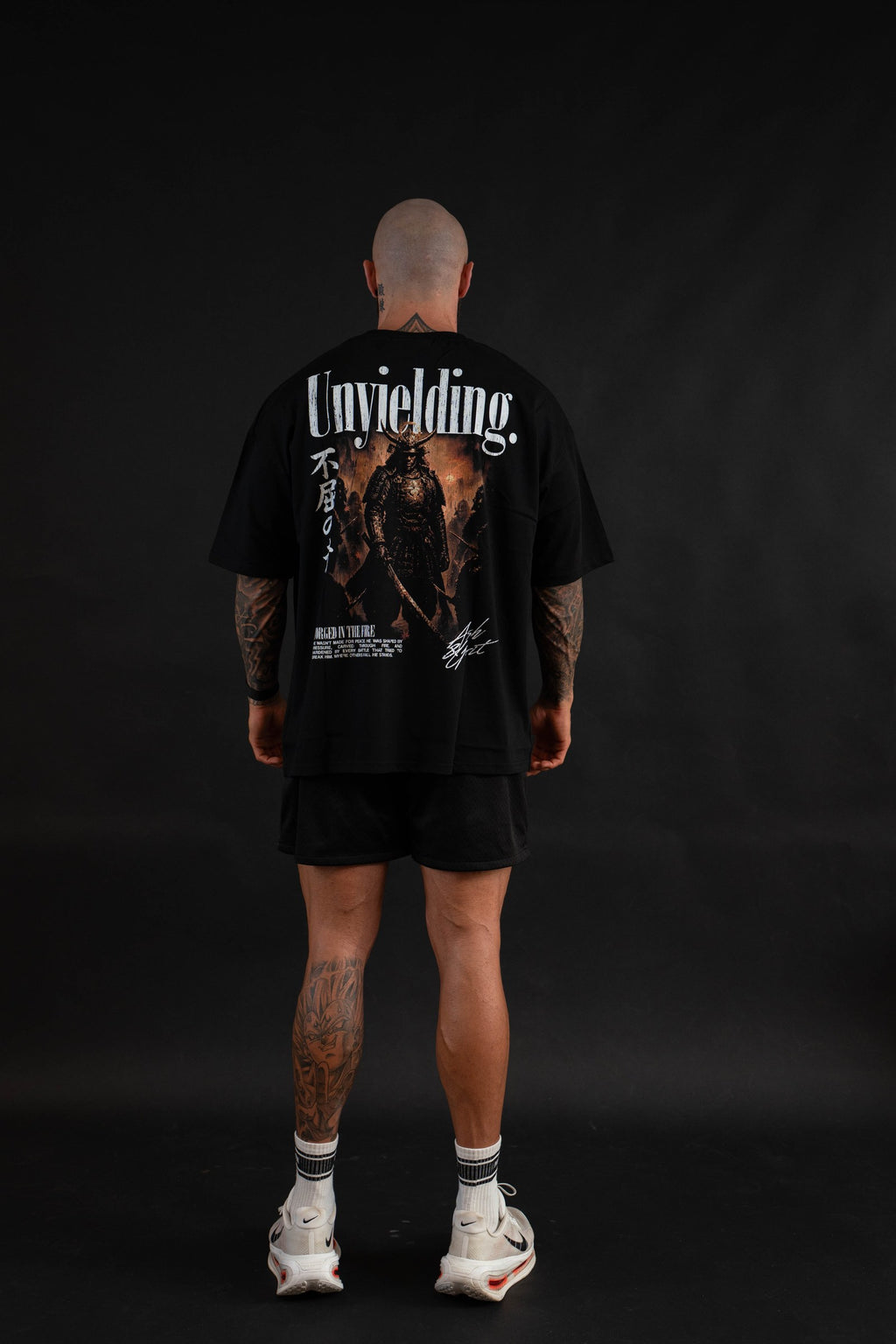Unyielding T-Shirt back graphic on a male model