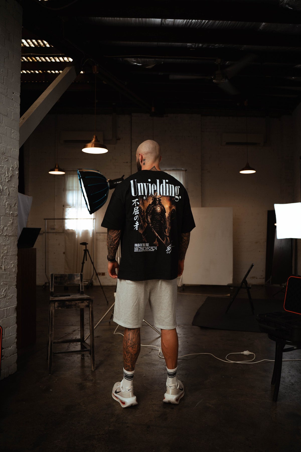 Unyielding T-Shirt back graphic worn by a male model in the studio