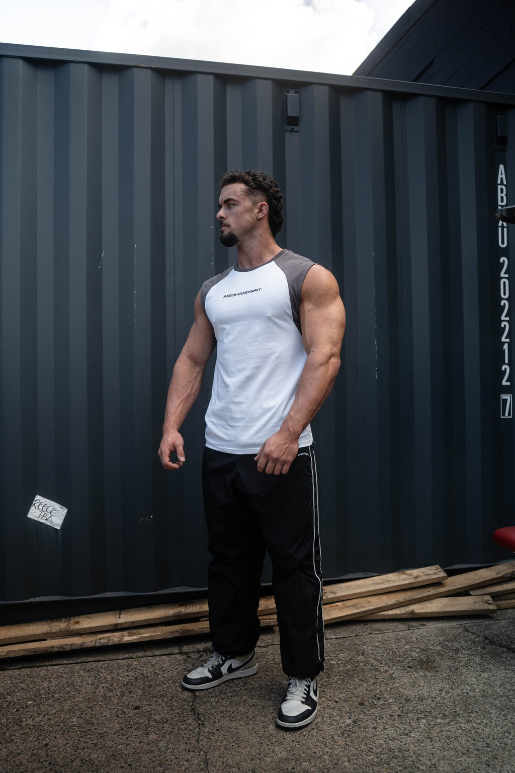 Pursuit Tank in white and charcoal, worn by a model, front view