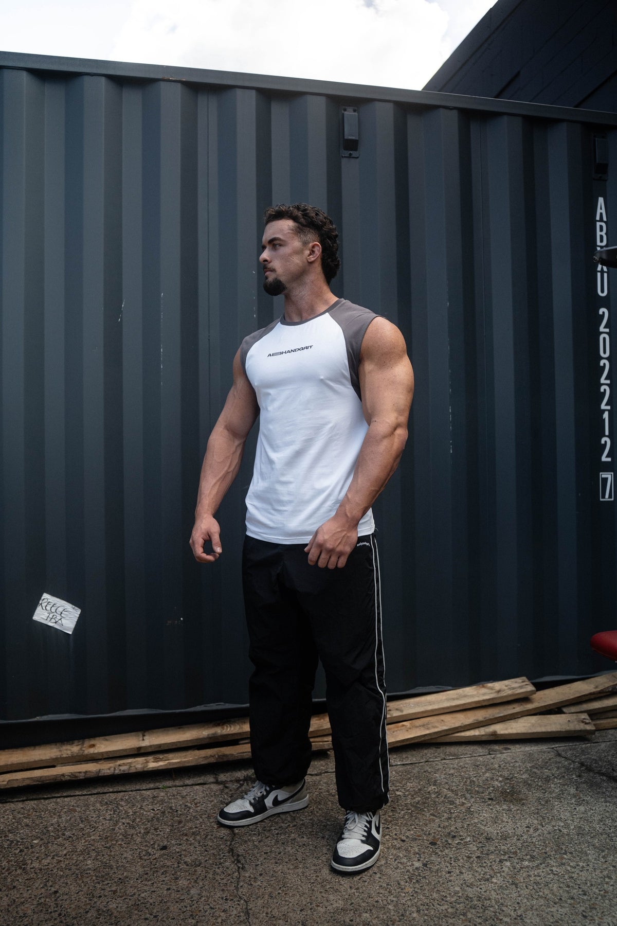 Pursuit Tank in white and charcoal, worn by a model, front view